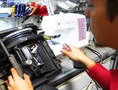 Vacuum repair technician servicing internal components on a workbench in South Bend, IN
