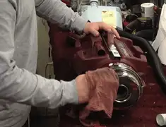 Vacuum repair technician cleaning and servicing a vacuum motor in South Bend, IN
