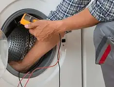 Washing machine repair technician testing a front-load washer with diagnostic tools in South Bend, IN